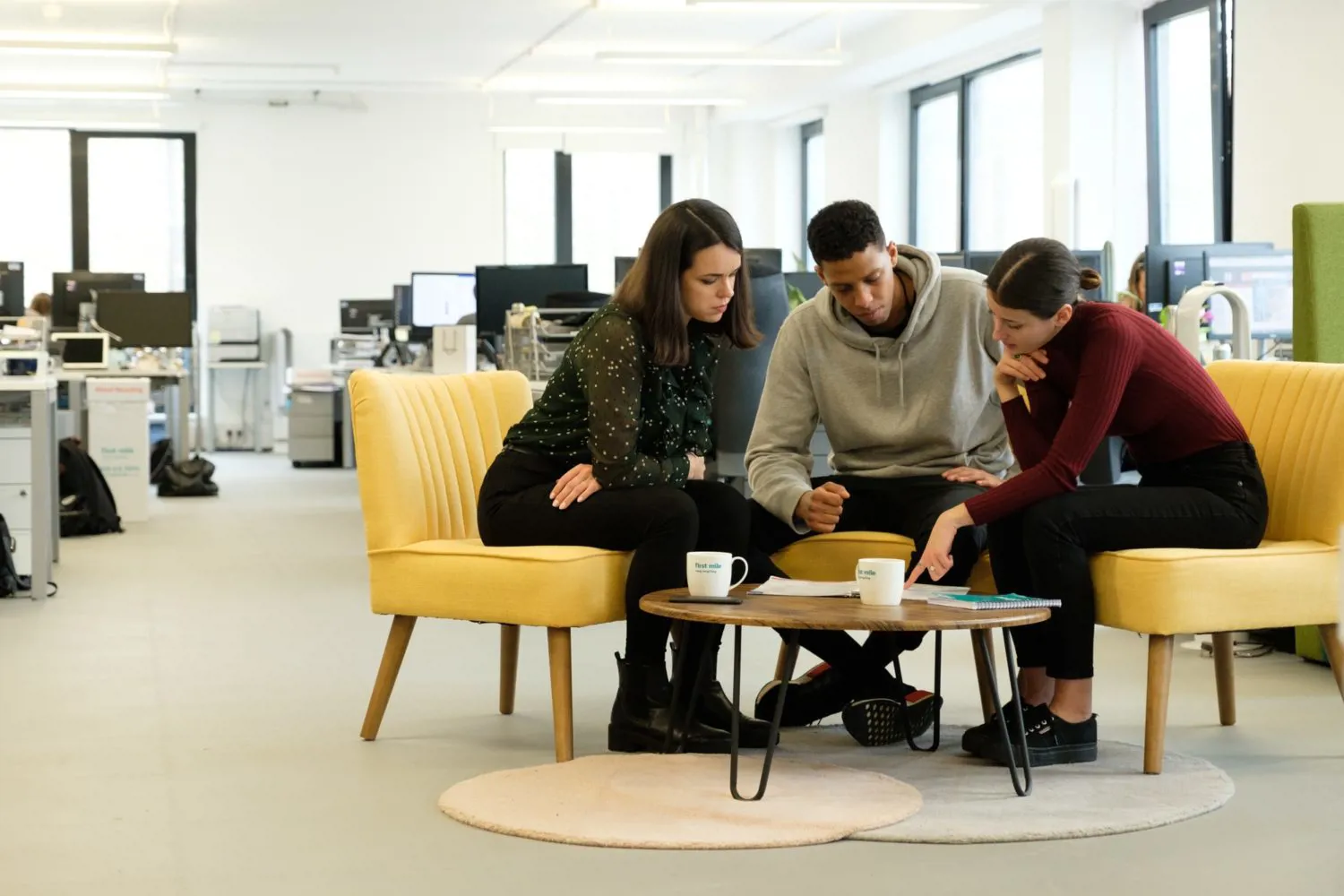 Office employees meeting together to discuss an idea.